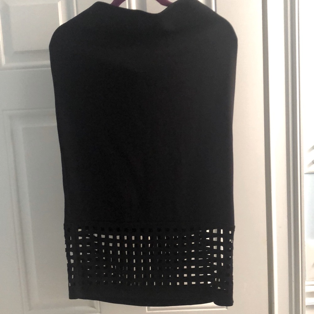 Black stretchy pencil skirt with checker-board cut-outs on the bottom.